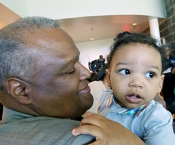 Prince George's County Executive Rushern L. Baker III holds Christian Rhodes Jr., 1, after the county's Health Department introduced a new program to encourage reading and boost early childhood education at the Cheverly Health Center Atrium May 3. (William J. Ford/The Washington Informer)