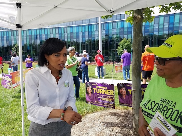 Prince George's County State's Attorney Angela Alsobrooks (left), who is running for county executive, chats with a volunteer outside the Southern Regional Technology and Recreation Complex in Fort Washington, Maryland, on June 14, the first day of early voting in the state. (William J. Ford/The Washington Informer)