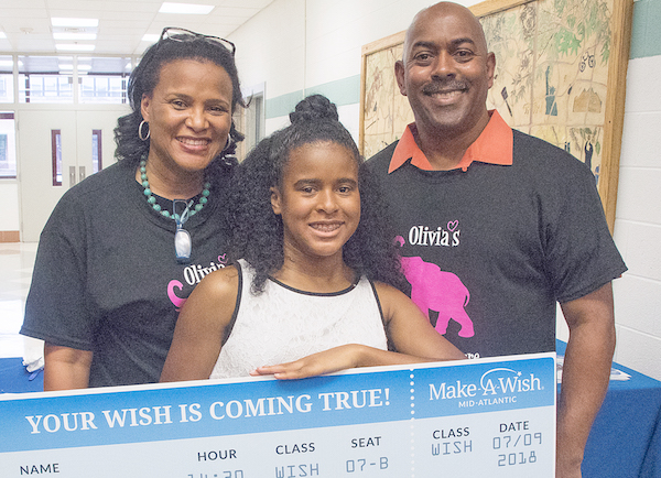 Kevin and Schonay Jones with their daughter Olivia, who received a trip to South Africa from Make-A-Wish Mid-Atlantic during an 8th grade farewell ceremony in Silver Spring, Md., on June 8 (Shevry Lassiter/The Washington Informer)