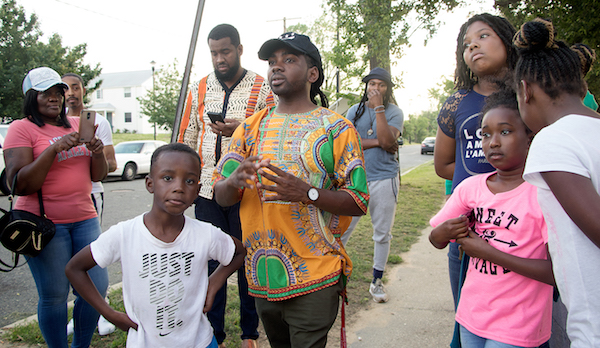 Ward 8 Council member Trayon White stands with local residents at a June 1 prayer vigil, where several homicides have taken place near Ferebee Hope Elementary School in southeast D.C. (Shevry Lassiter/The Washington Informer)
