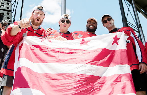 From left: Washington Capitals players Philipp Grubauer, Jakub Vrana, Devante Smith-Pelly and Brett Connolly celebrate with fans during the Stanley Cup championship parade on the National Mall in D.C. on June 12. (Khalid Naji-Allah)