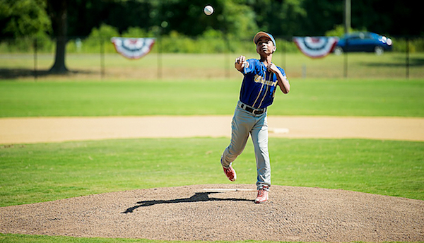 William Palmer of the Cheverly Boys and Girls Club throws out the first pitch as part of Major League Baseball All-Star festivities at renovated baseball field at Walker Mill Regional Park in Capitol Heights on July 14. (Courtesy of MLB)