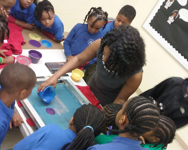 YEI founder Tachara Crump works with KidBiz participants. (Courtesy of YEI)