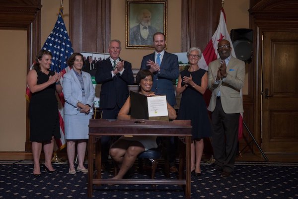 D.C. Mayor Muriel Bowser on July 10 signs the District of Columbia Green Finance Authority Establishment Act of 2018, officially making Washington, DC the first city in the United States to establish a green bank. (Courtesy of Bowser's office via Twitter)