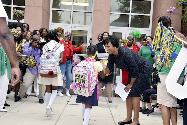 D.C. Mayor Muriel Bowser greets students at Excel Academy in Southeast, the city’s first all-girl public school, on Aug. 20, the first day of the 2018-2019 traditional school year. (Robert Roberts/The Washington Informer)