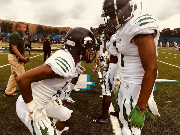 Members of Charles H. Flowers High School's football team line up on the field before a recent game. (Courtesy of Visionary Media Productions)
