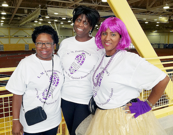 Pamela Price (center) runs L.M. Foundation of Temple Hills, which organized an Oct. 6 domestic violence walk at the Wayne K. Curry Sports and Learning Complex. Wanda Washington (left) and Tomika Douglas, two domestic violence survivors, participate in the walk. (William J. Ford/The Washington Informer)
