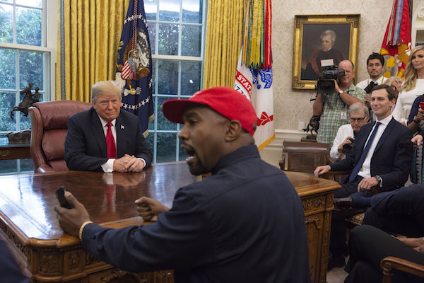 President Donald Trump meets with rapper Kanye West in the Oval Office of the White House in Washington D.C. on Oct. 11, 2018. (Photo by Calla Kessler/The Washington Post via Getty Images)