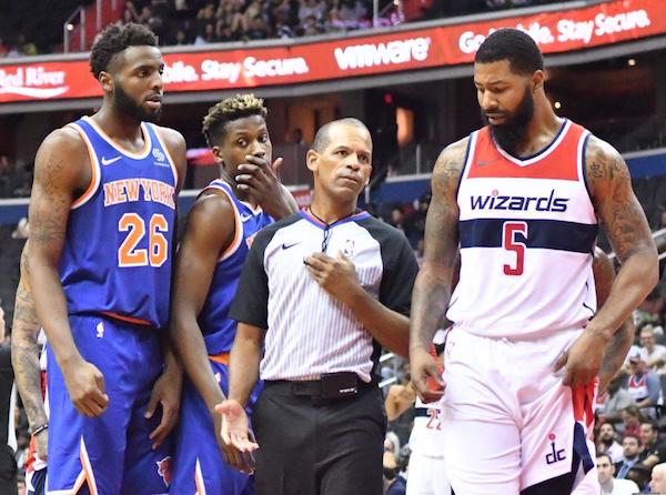 Referee Eric Lewis steps in between Washington Wizards forward Markieff Morris (5) and New York Knicks center Mitchell Robinson after a verbal altercation in the second quarter of the Knicks' 124-121 preseason win at Capital One Arena in D.C. on Oct. 1. (John De Freitas/The Washington Informer)