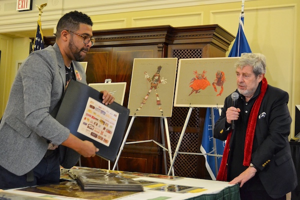 Solomon Haile Selassie (left), production specialist at the Library of Congress who organized a 40th anniversary event for "The Wiz," shows sketches from the film that are explained by Tony Walton, the movie's production and costume designer, at the Library of Congress in D.C. on Oct. 27. (Brigette Squire/The Washington Informer)
