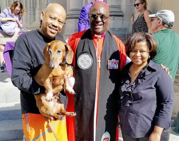 Bishop Carl Wright with Virgil and Rosalind Young and their pet Cousteau after receiving a blessing at the National Cathedral (Jacqueline Fuller/The Washington Informer)