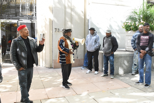 **FILE** Yango Sawyer uses a bullhorn to speak to returning citizens gathered for a protest at the City Paper headquarters in northwest D.C. on Oct. 16. (Roy Lewis/The Washington Informer)