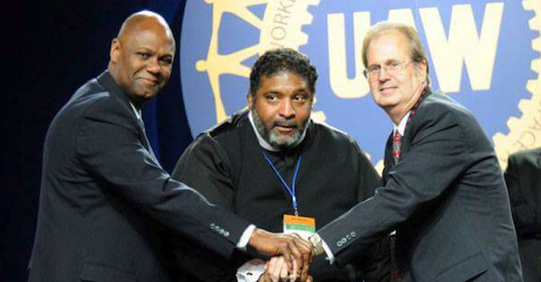 UAW Secretary-Treasurer Ray Curry, Rev. William Barber II, and UAW President Gary Jones stand in solidarity following Rev. Barber’s speech on equality.