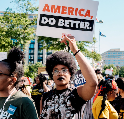 5 A woman holds a sign while marching to Freedom Plaza during the 2nd annual March for Black Women in Washington, D.C on Saturday, Sept. 29. (Michael A. McCoy/The Washington Informer)