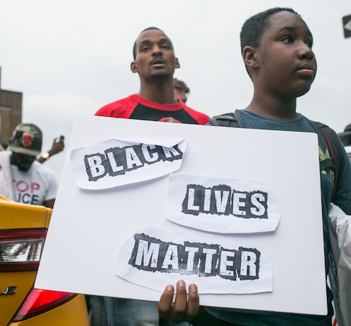**FILE** A young boy holds a sign reading, "Black Lives Matter" on July 7, 2016. Thousands rallied calling for an end to the epidemic of unsanctioned police murder occurring in black communities across the United States. (Photo by Karla Ann Cote/NurPhoto via Getty Images)