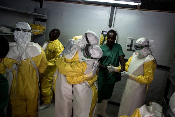 Health workers embrace whilst putting on their personal protective equipment (PPE) before heading into the red zone at a newly build MSF (Doctors Without Borders) supported ebola treatment centre (ETC) on November 7, 2018 in Bunia, Democratic Republic of the Congo. - The death toll from an Ebola outbreak in eastern Democratic Republic of Congo has risen to more than 200, the health ministry said on Nov. 10, 2018. (JOHN WESSELS/AFP/Getty Images)