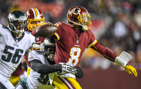 Washington Redskins quarterback Josh Johnson (8) is wrapped up by Philadelphia Eagles defensive tackle Treyvon Hester (90) in the third quarter of the Eagles' 24-0 win at FedEx Field in D.C. on Dec. 30. (Photo by Jonathan Newton/The Washington Post via Getty Images)