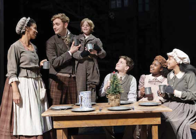 Yesenia Iglesias and Gregory Maheu as the Cratchits and (children) Aidan Fuller, Vaughn Mussmon, Madison K. Fields and Ariel Russell in Ford’s Theatre’s “A Christmas Carol,” now through Dec. 30. (Photo by Scott Suchman)