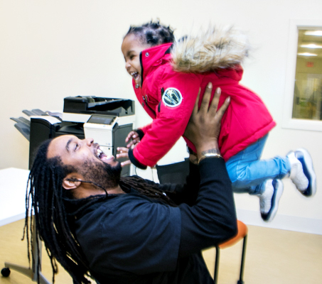Dontike Miller, 35, picks up his daughter Samantha, 2, from day care after his attendance at Bright Beginnings, Inc.'s "Bridging the Gap," a 12-week program that teaches fathers to manage life with their homeless families. (Shevry Lassiter/The Washington Informer)