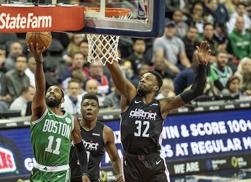 Boston Celtics guard Kyrie Irving attempts a layup against Washington Wizards forward Jeff Green during the Celtics' 130-125 overtime win at Capital One Arena in D.C. on Dec. 12. (Yusuf Abdullah/Special to The Informer)