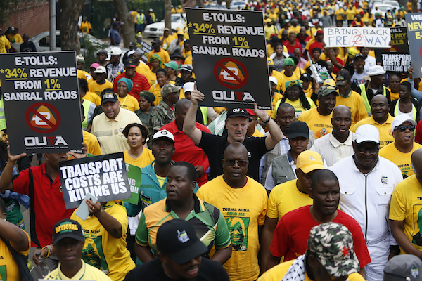 African National Congress (ANC), Congress of South Africa Trade Unions (Cosatu) and members of various civil organisations hold placards as they march to The Union Buildings in Pretoria on November 2, 2018, to protest against an e-tolling system. (Photo by Phill Magakoe/AFP/Getty Images)