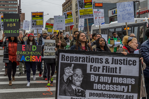 A coalition of NYC Black Lives Matter activists and environmental justice groups marching on the 51st anniversary of the assassination of Malcolm X to demand justice for the people of Flint, Michigan. (Photo by Erik McGregor/Pacific Press/LightRocket via Getty Images)