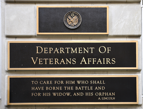 **FILE** A metal plaque on the facade of the Department of Veterans Affairs building in Washington, D.C., features a quotation by Abraham Lincoln. (Photo by Robert Alexander/Getty Images)