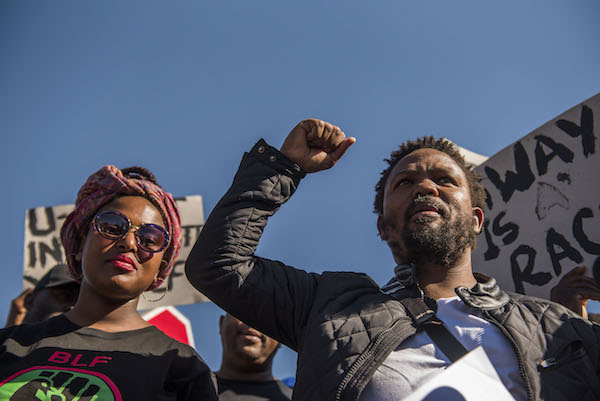**FILE** Black Land First (BLF) members led by Andile Mngxitama and Zanele Lwaini protests outside MiWay Insurance headquarters following an allegedly fake email scandal on July 21, 2017 in Centurion, South Africa. BLFs visit sought to get clarity on the company's stand on racism after a viral screenshot of an email purportedly between MiWay officials, saying that the company had decided to reject 90% of the claims from black people, referring to them as baboons. MyWay issued a statement declaring the email as fake. CEO Rene Otto, who met with BLF leaders, said they have enlisted the help of an independent forensic expert after an internal probe linked the fake email to a disgruntled client. (Photo by Alet Pretorius/Gallo Images/Getty Images)