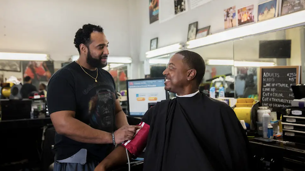 Barber Eric Muhammad (left) and customer Mark Sims (Smidt Heart Institute at Cedars-Sinai)