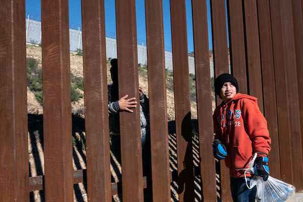 A boy who arrived in Mexico with other Central American migrants hoping to reach the United States cries after her mother crossed the US-Mexico border fence from Tijuana, Baja California State, Mexico, to the US, on December 30, 2018. (GUILLERMO ARIAS/AFP/Getty Images)