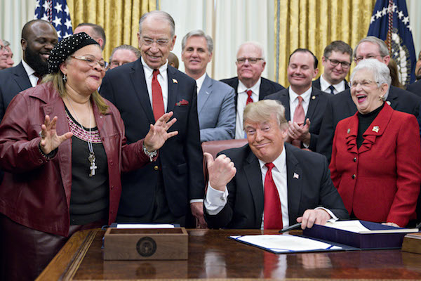 **FILE** President Donald Trump (center) gestures as Alveda King, niece of Reverend Martin Luther King Jr., speaks during a signing ceremony for S. 756, First Step Act and H.R. 6964, Juvenile Justice Reform Act with Senator Chuck Grassley, a Republican from Iowa, second left, and Representative Virginia Foxx, a Republican from North Carolina, right, in the Oval Office of the White House in Washington, D.C., U.S., on Friday, Dec. 21, 2018. (Andrew Harrer/Bloomberg via Getty Images)