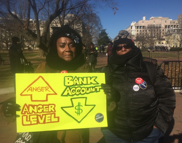 Lavette Lightford and Lori Mac, members of the National Treasury Employees Union, particpate in a Jan. 10 march in D.C. against the government shutdown. (Barrington M. Salmon/TriceEdney News Wire)