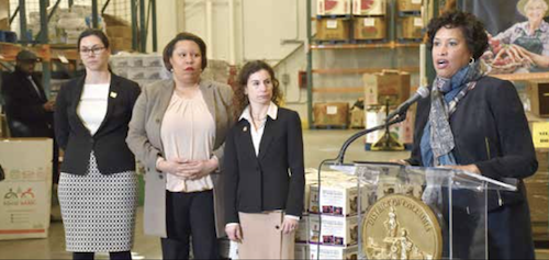 Mayor Bowser speaks to volunteers and the press at the Capital Area Food Bank in Northeast on Tuesday, Jan. 22, where she announced ways the DC government is stepping up to assist residents and families impacted by the Federal government shutdown. Standing with Mayor Bowser are (L-R) Jenny Reed, director of the D.C. Office of Budget and Performance Management, Dr. Unique Morris-Hughes, director of the D.C. Department of Employment Services, and Dr. Laura Zeilinger, director of the D.C. Department of Human Services. (Robert Roberts/The Washington Informer)