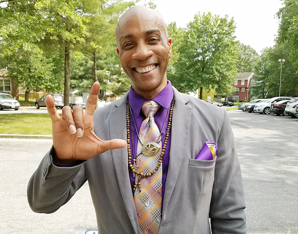 Rev. Raymont Anderson says the word "heaven" in American Sign Language. (Jacqueline Fuller/The Washington Informer)