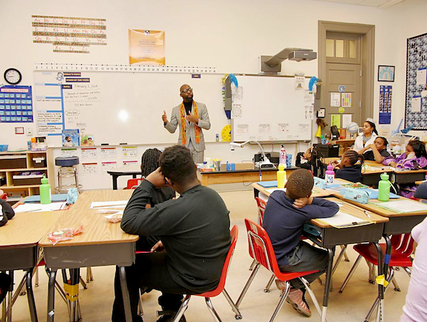 Duvalier Malone speaks to the students at Democracy Prep Congress Heights Public Charter School for the kickoff of Black History Month. (Courtesy of Democracy Prep PCS via Facebook)
