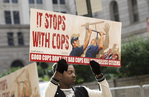 **FILE** A demonstrator holds a sign during the trial of Police Officer William Porter at Baltimore City Circuit Courthouse on December 16, 2015. (Molly Riley/AFP/Getty Images)