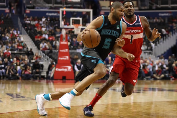 Nicolas Batum of the Charlotte Hornets dribbles past Trevor Ariza of the Washington Wizards during the first half at Capital One Arena on March 15, 2019 in Washington, D.C. (Patrick Smith/Getty Images)
