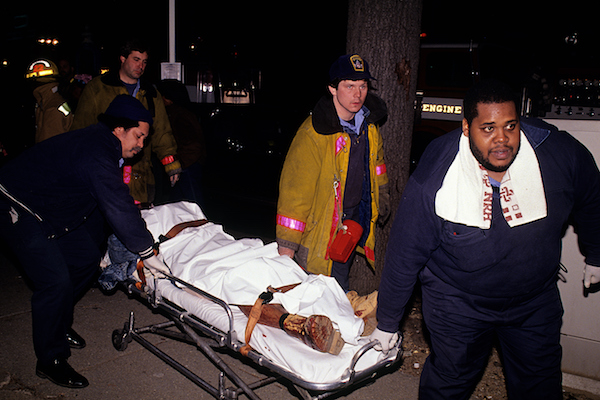 **FILE** D.C. paramedics and firemen roll a stretcher with a DOA drug shooting victim on it to the morgue wagon. (Mark Reinstein/Corbis via Getty Images)