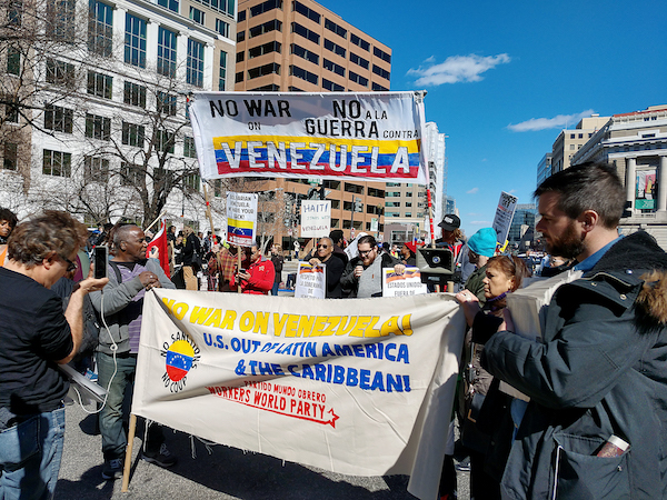 Protesters opposed to U.S. intervention into Venezuela marched to the Trump Hotel after a rally at Lafayette Square across from the White House on March 16. Speakers called on the Trump administration to use peaceful means to resolve the political, social and economic crisis in Venezuela instead of military force. (Barrington M. Salmon/Special to The Informer)