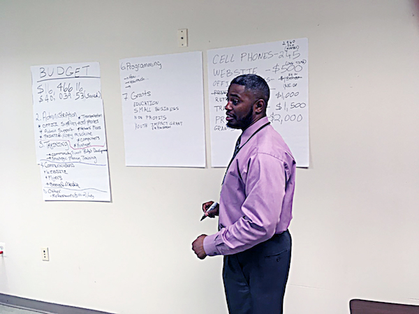 Salim Adofo, advisory neighborhood commissioner for 8C07, explains details of the ANC's budget to residents. (James Wright/The Washington Informer)