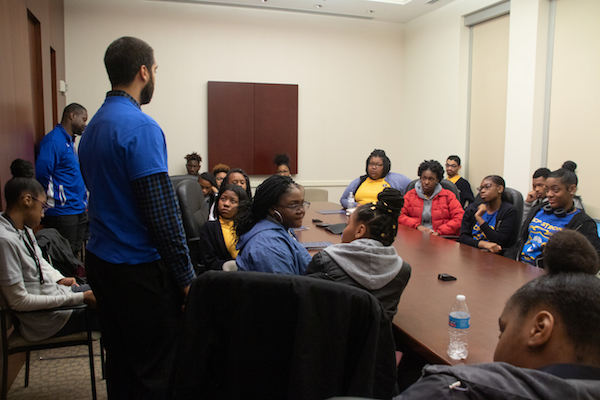 Samuel Korpoi (far left), a physical education teacher, and school counselor Nigel Jackson along with Alicia N. Waldon (not shown), director of curriculum and assessment, escort a group of 24 students from National Collegiate Preparatory Public Charter High School to the John A. Wilson Building in northwest D.C. with the hope of meeting with D.C. Council members to share concerns for their school's closing on March 26. (Shevry Lassiter/The Washington Informer)