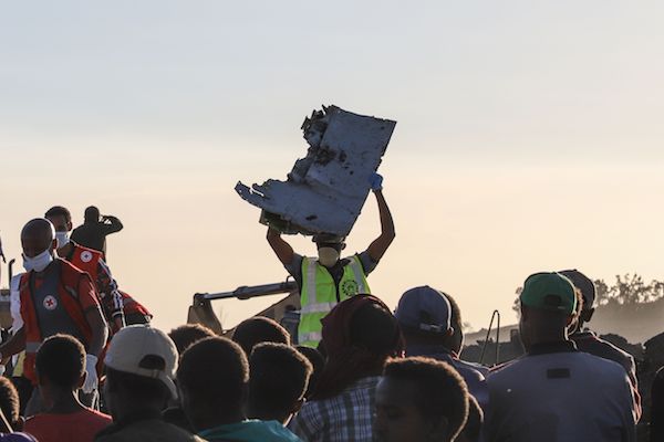 A man carries a piece of debris on his head at the crash site of a Nairobi-bound Ethiopian Airlines flight near Bishoftu, a town some 60 kilometers southeast of Addis Ababa, Ethiopia, on March 10, 2019. A Nairobi-bound Ethiopian Airlines Boeing crashed minutes after takeoff from Addis Ababa on March 10, killing all eight crew and 149 passengers on board, including tourists, business travelers, and "at least a dozen" UN staff. (Michael Tewelde/AFP/Getty Images)