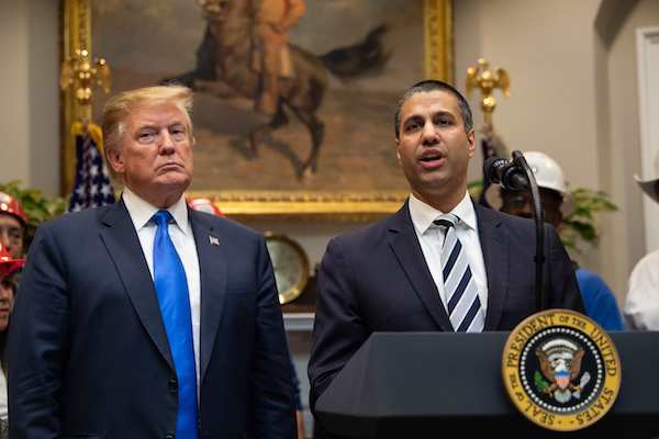 **FILE** President Donald Trump listens to Federal Communications Commission (FCC) chairman Ajit Pai speak during an announcement about 5G network deployment in the Roosevelt Room at the White House in D.C. on April 12, 2019. (Nicholas Kamm/AFP/Getty Images)
