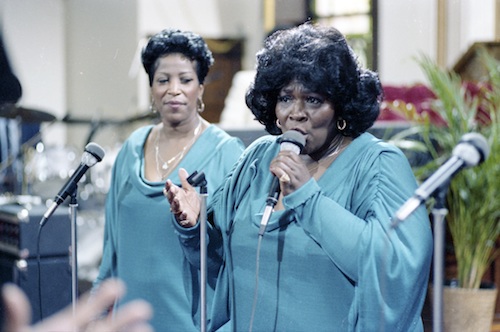 Billie Barrett Greenbey (left) and Delois Barrett Campbell, two of the Barrett Sisters, perform in a scene from the documentary "Say Amen, Somebody." (Smithsonian National Museum of African American History and Culture)