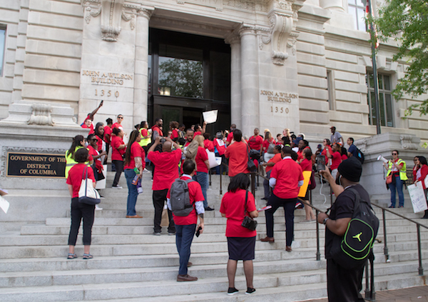Teachers and supporters rally at Freedom Plaza and on the steps of the Wilson Building in northwest D.C. on April 25 to protest funding cuts to the budget for D.C. Public Schools, most of which are in Southeast. (Shevry Lassiter/The Washington Informer)