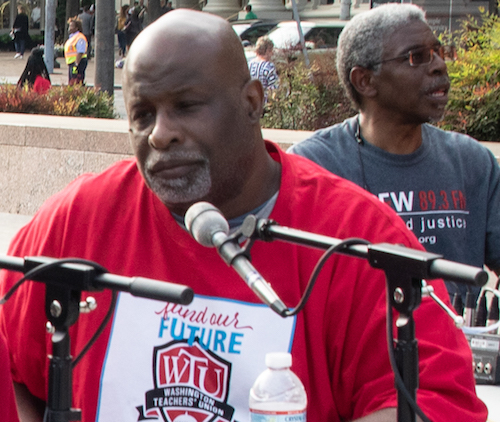 Jeff Canady participates in a conversation with WPFW-FM during a protest with teachers at Freedom Plaza in D.C. (Shevry Lassiter/The Washington Informer)