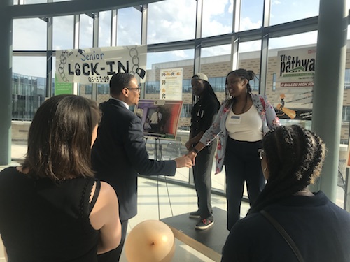 D.C. Schools Chancellor Lewis Ferebee greets Ballou Senior High School senior Amya McKoy during a ceremony honoring the Ballou Career Academy on Hospitality and Tourism on May 30. (Courtesy photo)
