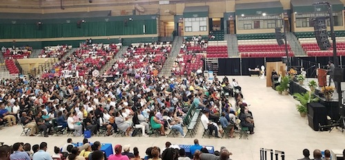 Benjamin Sinclari (onstage) gives advice to participants of the Prince George's County Summer Youth Enrichment Program during a kickoff event for the annual program at the Show Place Arena in Upper Marlboro on June 17. (William J. Ford/The Washington Informer)