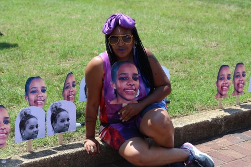 Queen Afi, pictured with a cut-out of her deceased daughter Smiley’s face, at an annual cookout and celebration of love, life, laughter and legacy in honor of the 19-year-old mother of one. (Courtesy photo)