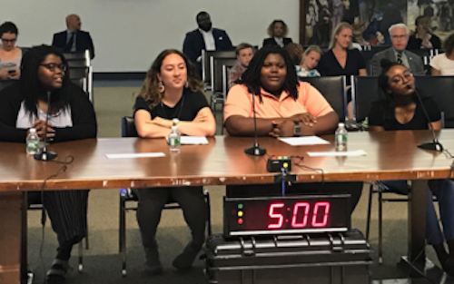 Hannah Dunn (Wilson High School), student representatives Tatiana Robinson (Ballou Senior High School) and Marjoury Alicea (Capital City Public Charter School), and Aaliyah Dick (Wilson High School) present the Student Advisory Committee's final report of the school year at June public meeting. (Courtesy of the DC State Board of Education)